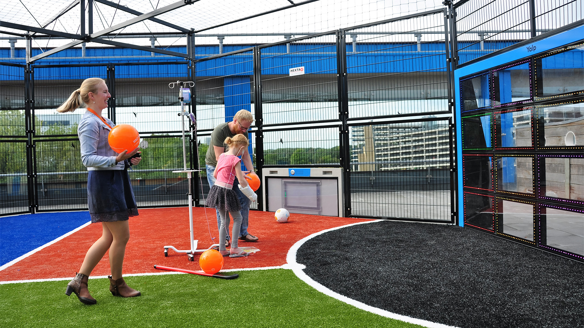 Children and adults engage in play on the Lappset Sutu during the unveiling of Wilhelmina Hospital's playground.