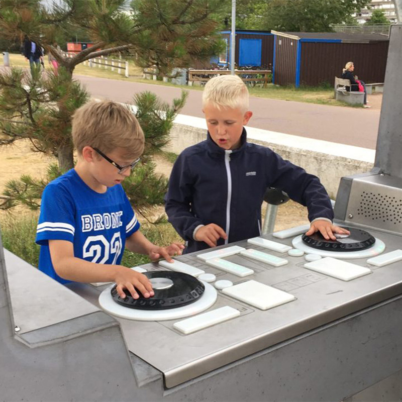 Two children playing on the Fono Interactive DJ booth