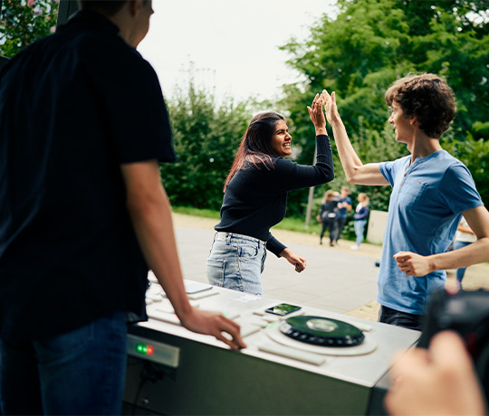 Teenagers dancing and enjoying music in front of the Fono Interactive DJ booth