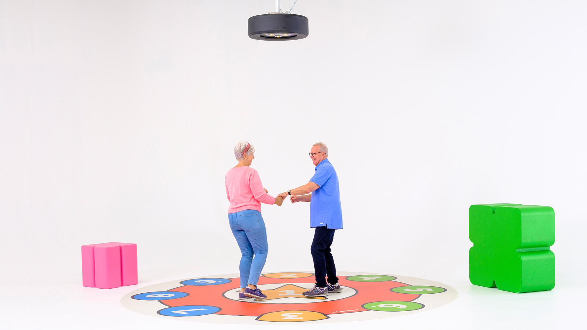 Two older adults dancing under the Lappset Luna | Lappset Group