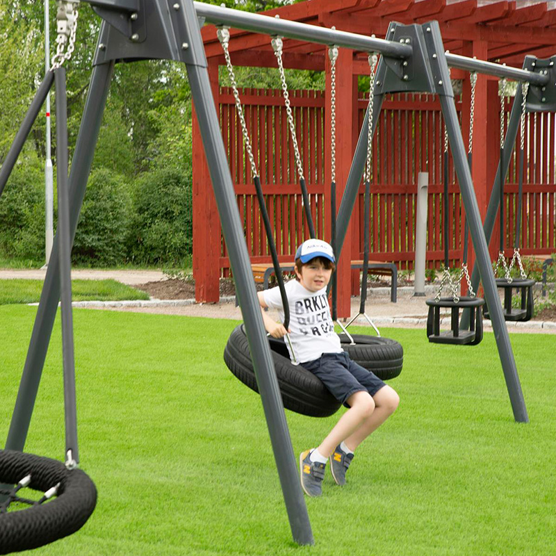 Child on a swing in norra Bäcklösa, Uppsala