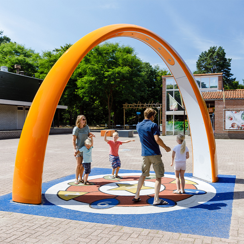 A family dancing under the Lappset Sona at Recreation park Het Grote Bos, The Netherlands