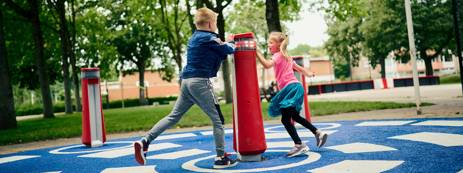 Two children play with a red Lappset Memo