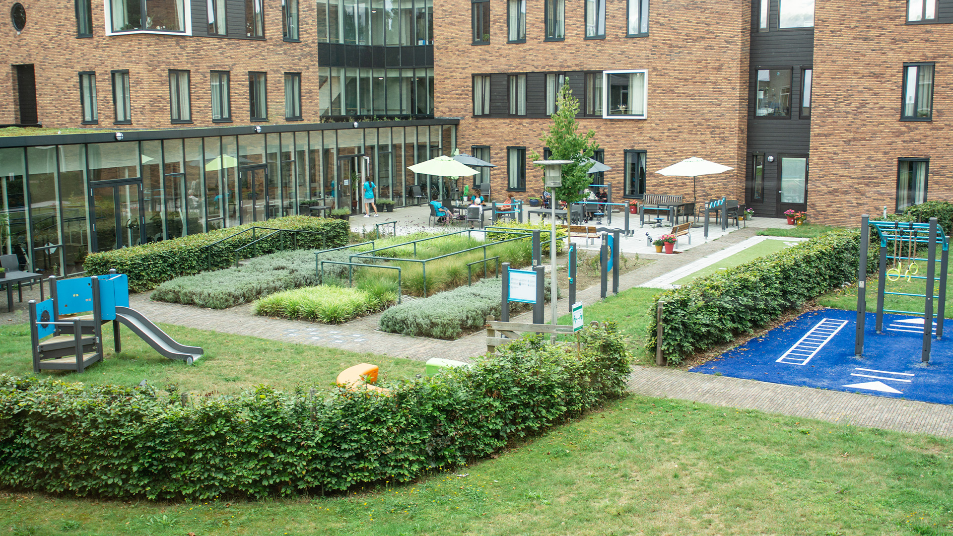 View of Norschoten Care Organization's Generation Garden with seating, garden, and play areas.