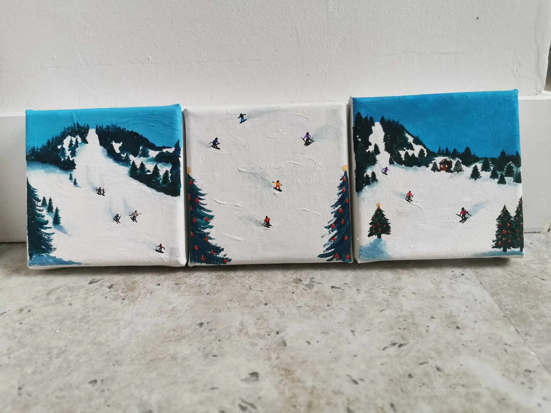 3 skiing paintings