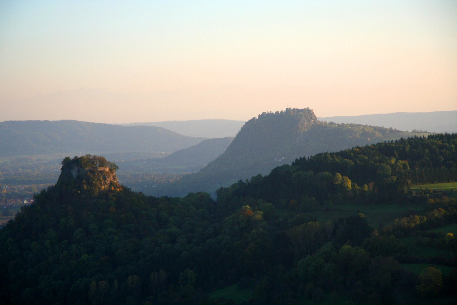 View of a landscape with wooded, volcanic hills.