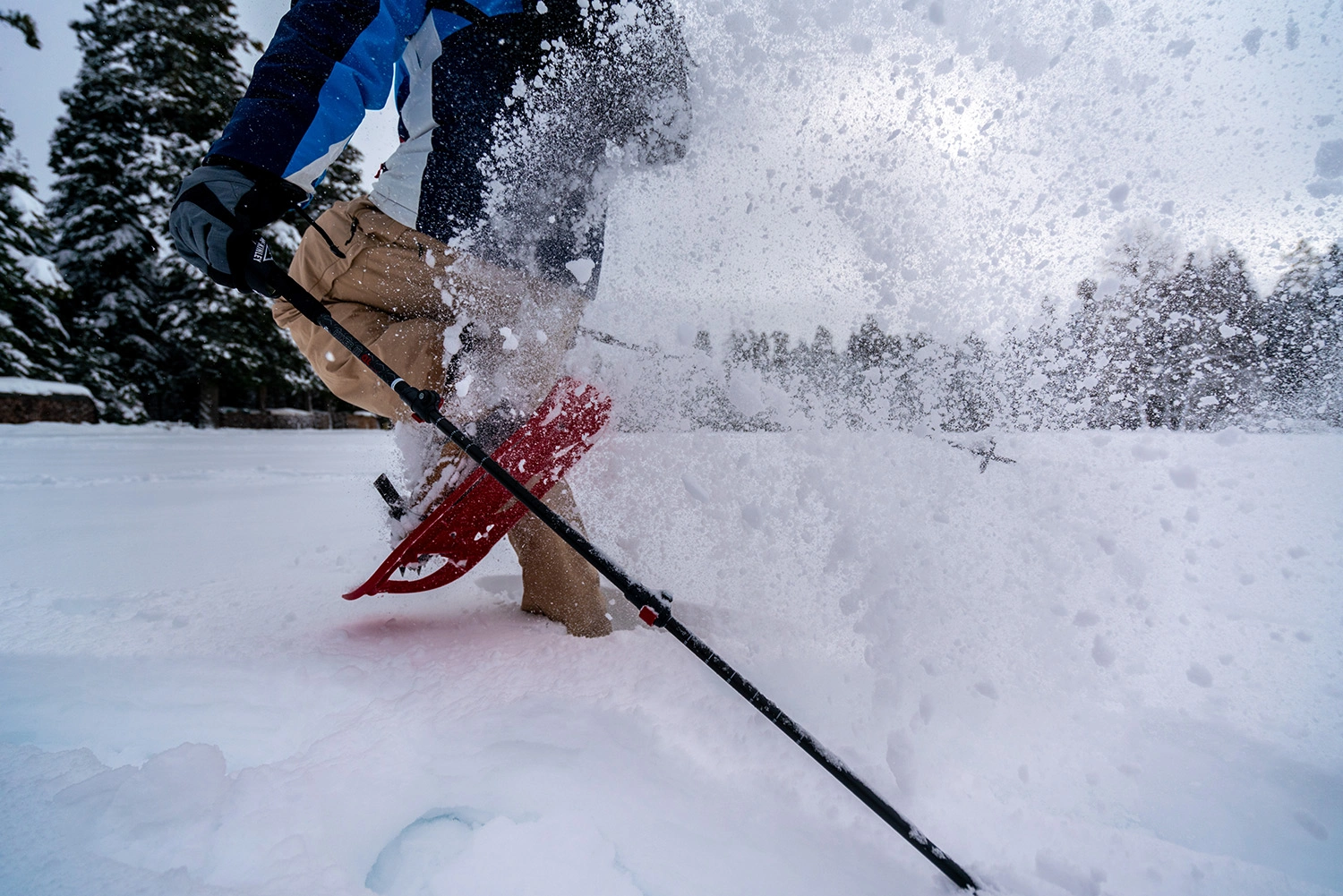 Close-up of a person snowshoeing in heavy snow.