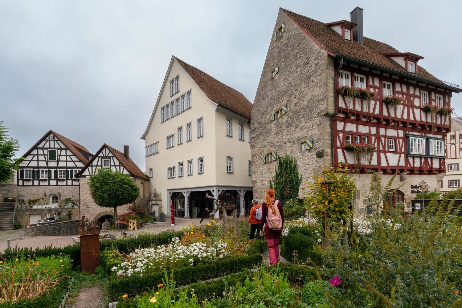  Flowers bloom and herbs grow in large beds on the market square in front of the town hall.