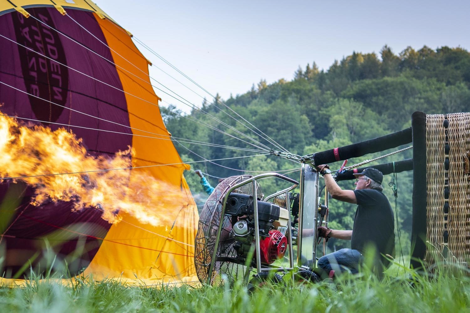 A man is launching a hot air balloon.