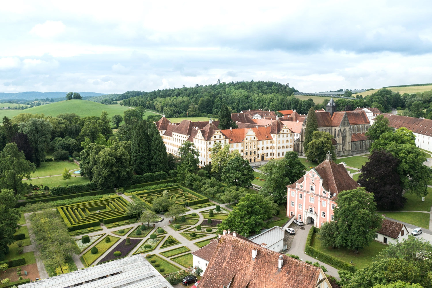 Aerial view of a castle with a green park.