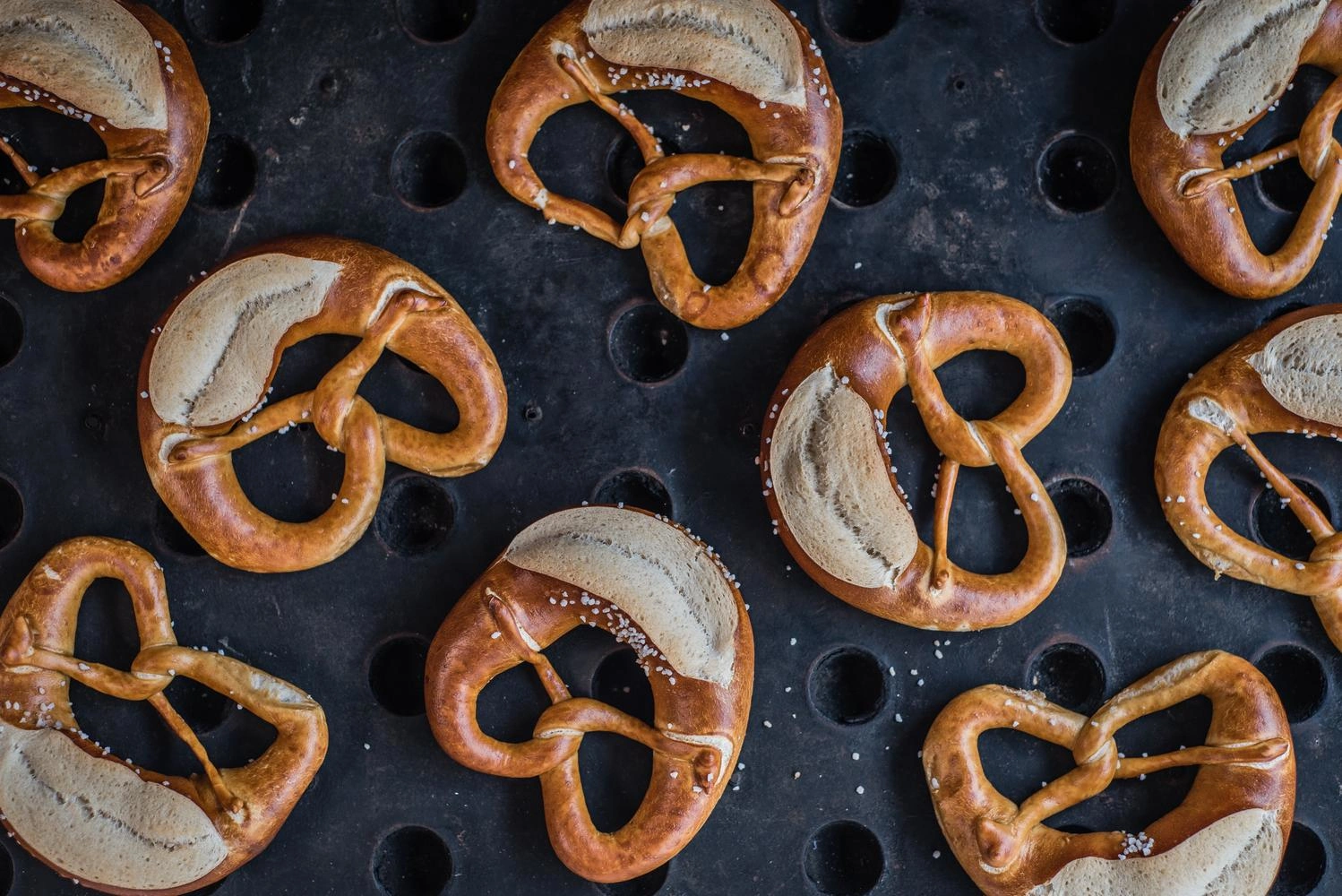 Top view of a tray with many pretzels.