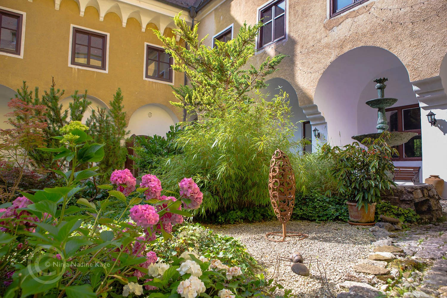 View into a romantic and lushly flowering inner courtyard