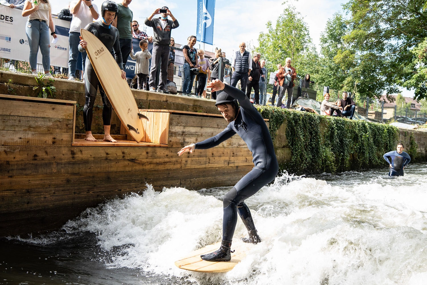 A person surfs a river wave