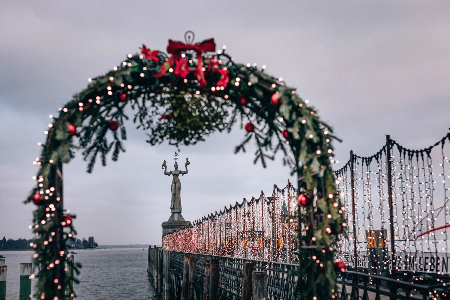 A harbor decorated for Christmas on a large lake.