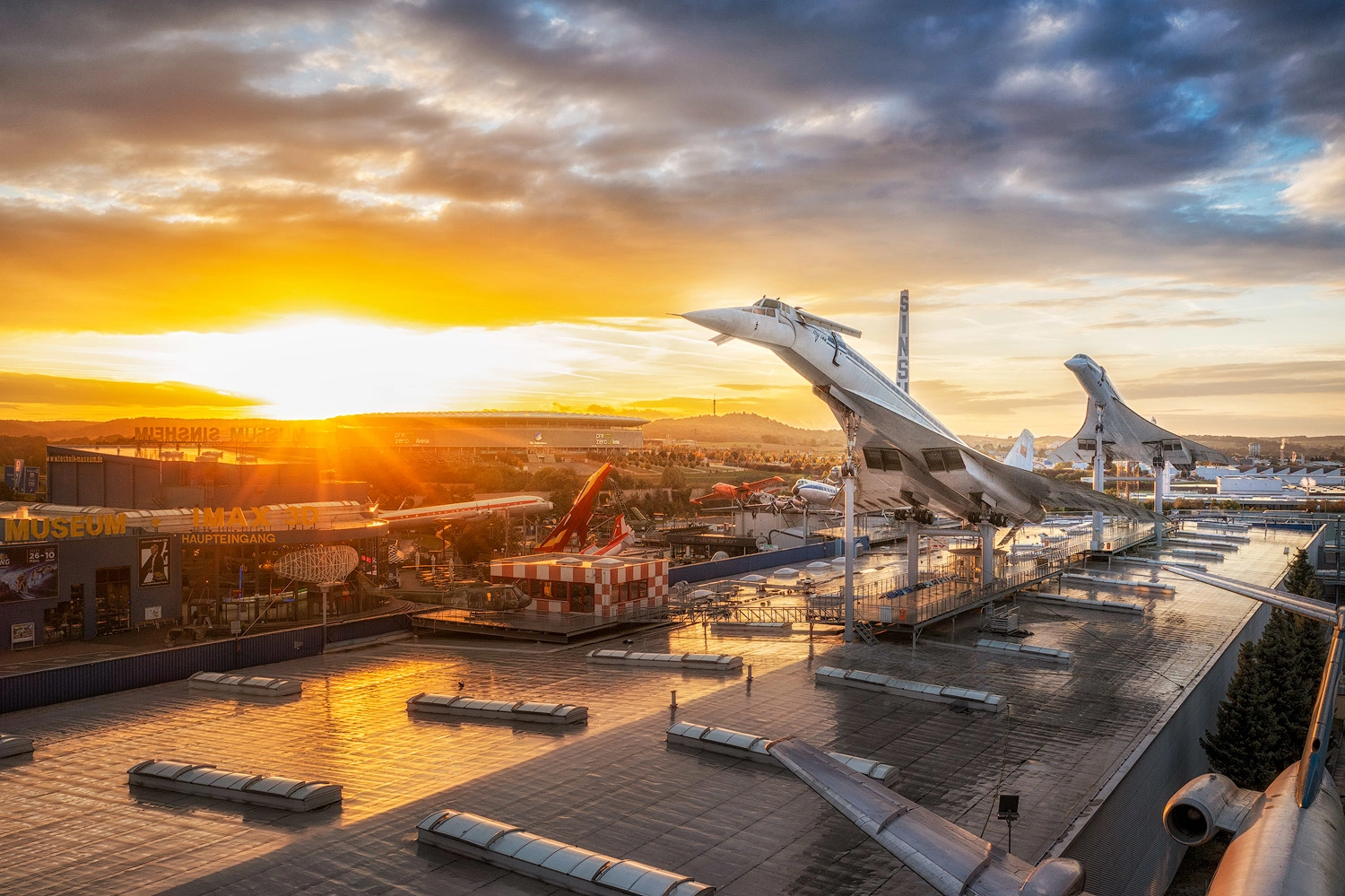 Exhibition of two Concorde supersonic passenger jets at sunset.