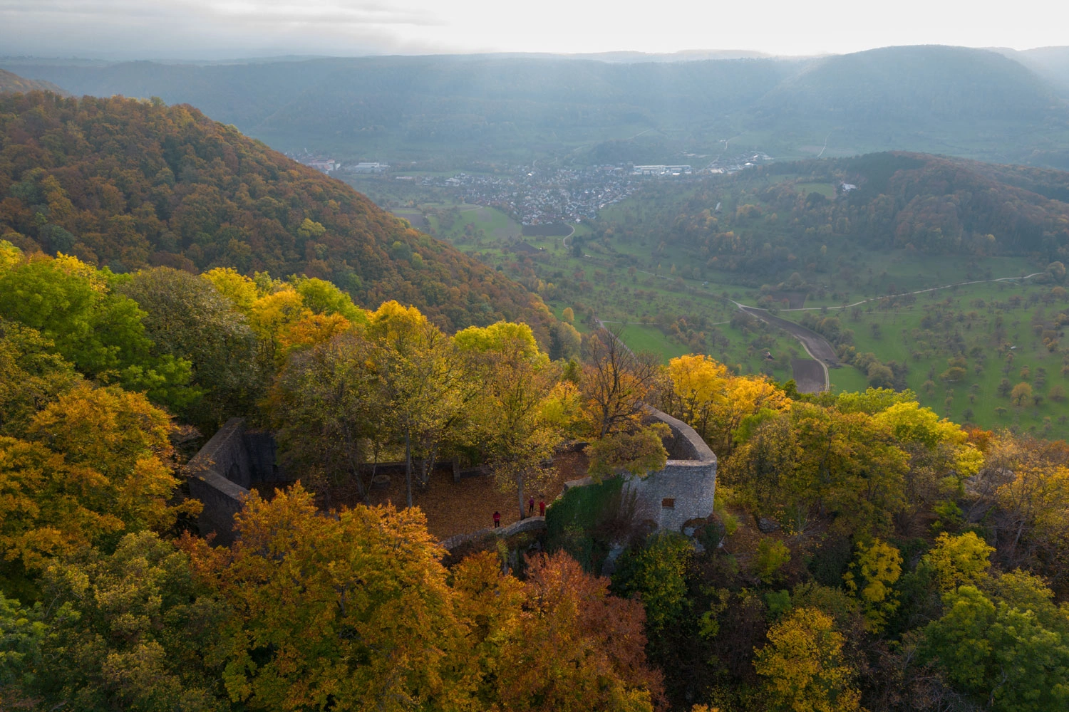  Ruin hidden in the colorful autumn forest.