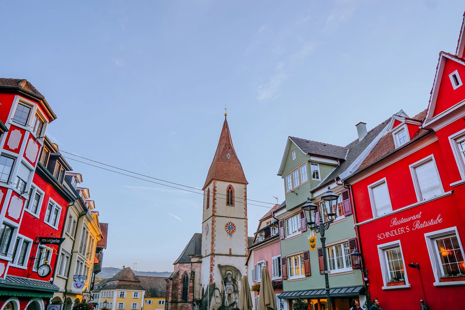 An alley in an old town leading to a church.