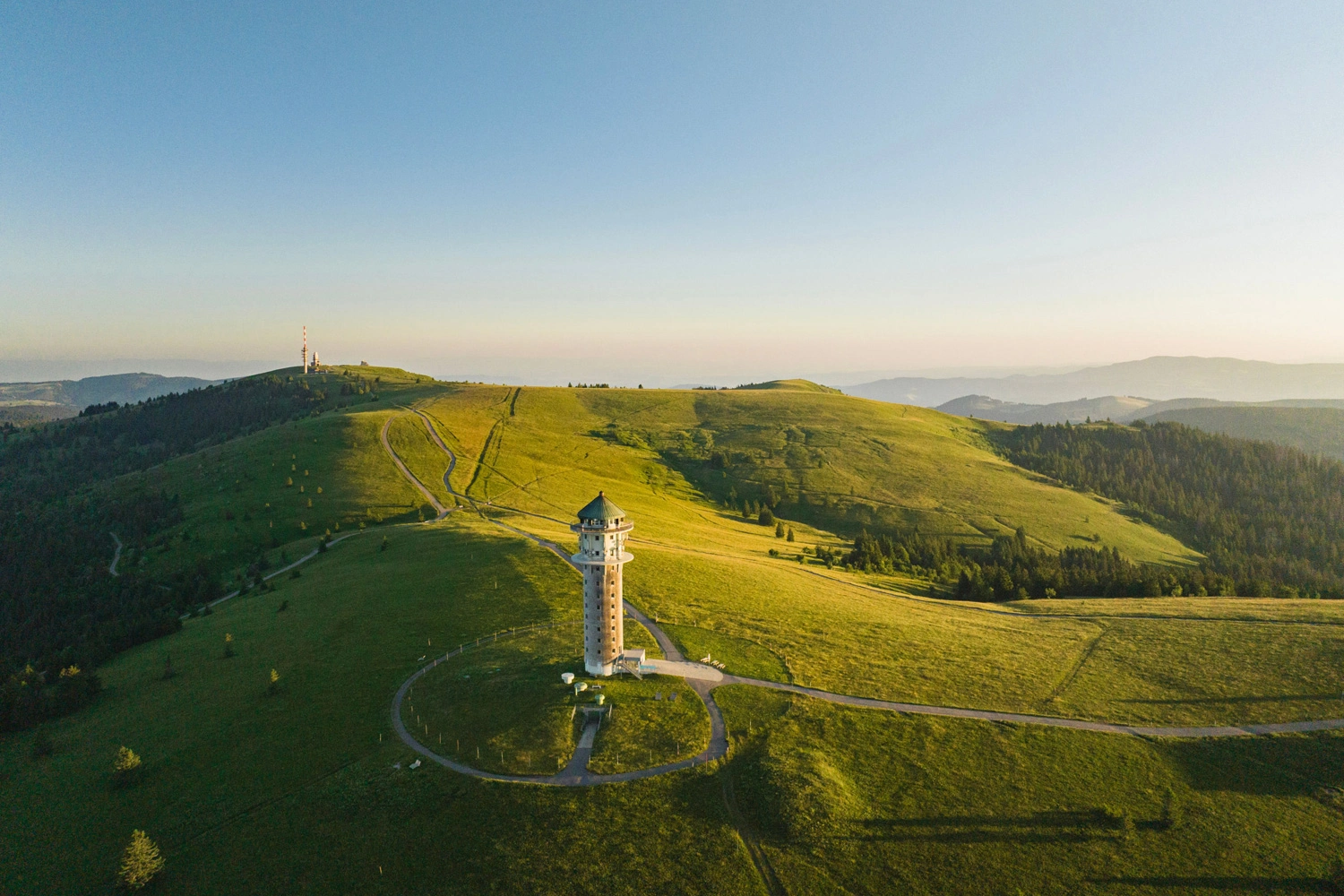 The Feldberg Tower on the Feldberg, surrounded by open high-altitude pastures and hiking trails.