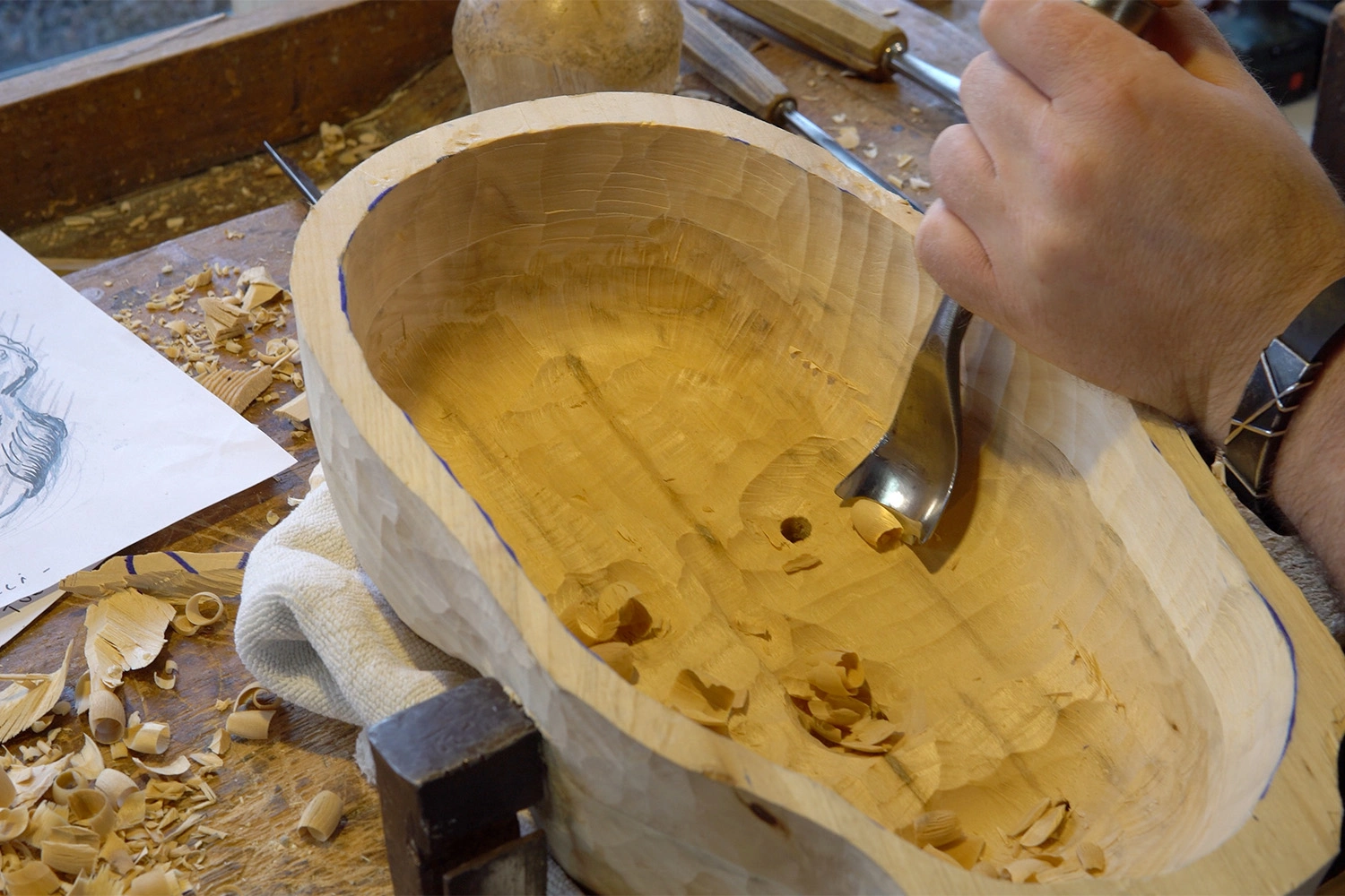 The masks are being hollowed out with the tools.