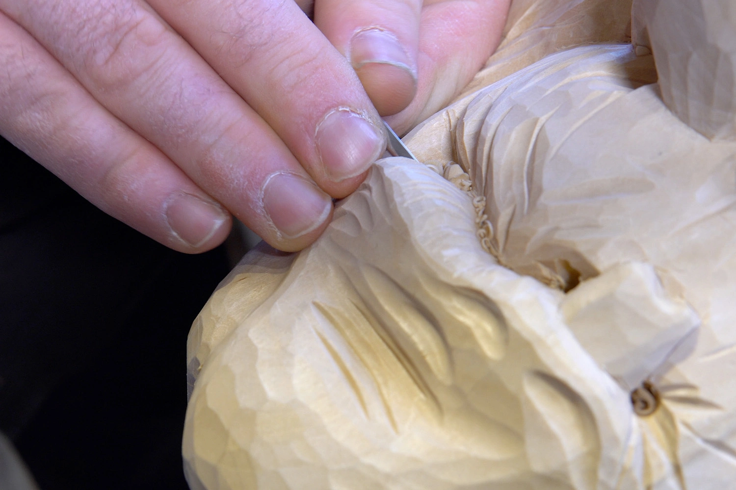 Small detail like the mouth and lips are being carved.