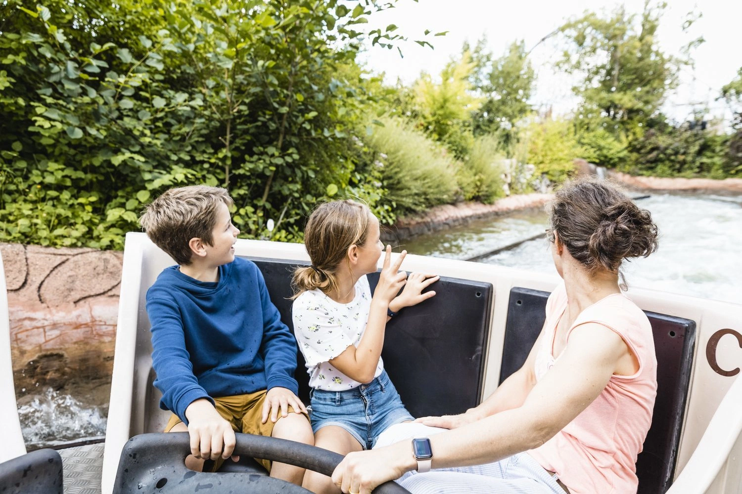 A family on a rafting ride in an amusement park