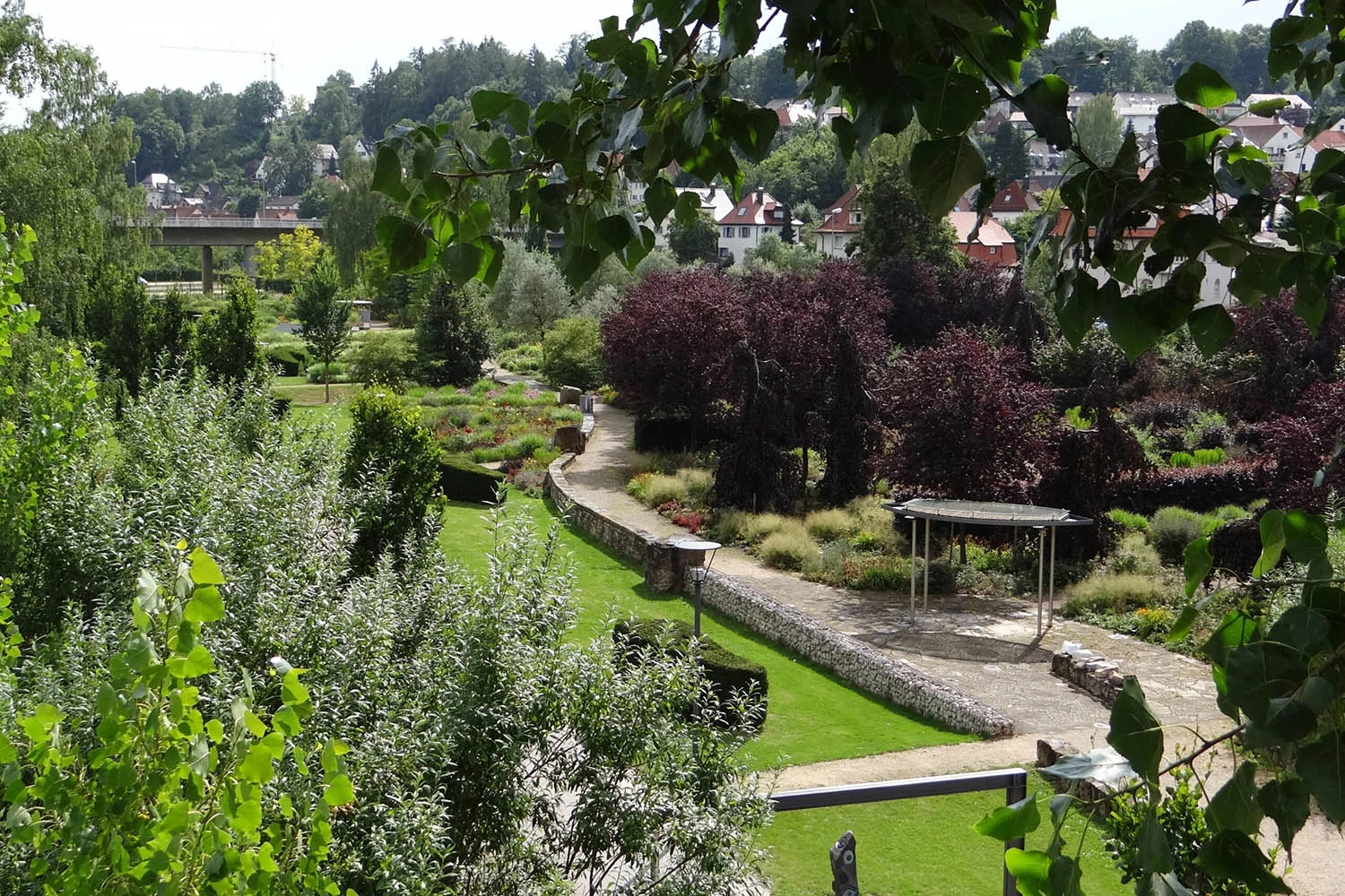 View of a park with lush greenery and flowering areas