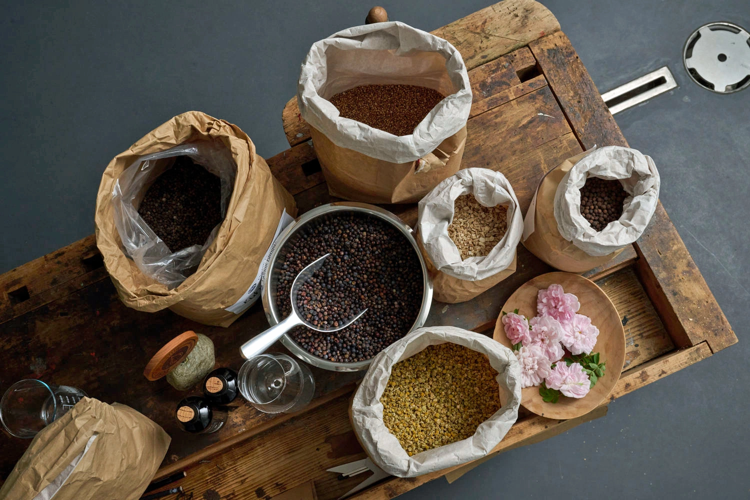 Top view of various bags with different spices on a rustic wooden board.