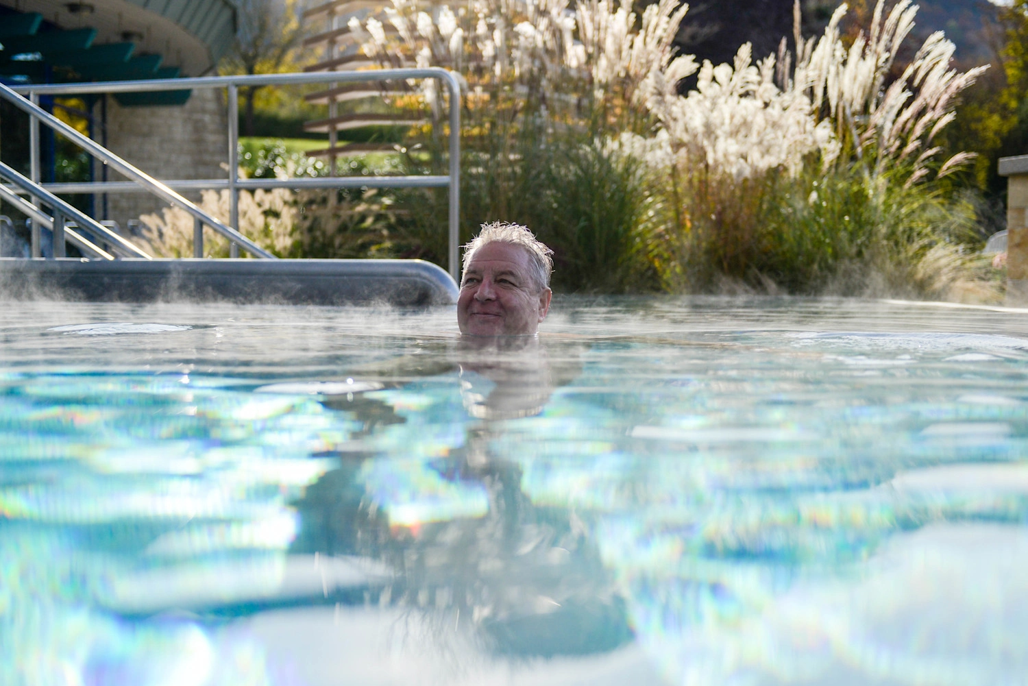 A man in the outdoor pool at Panorama Therme Beuren