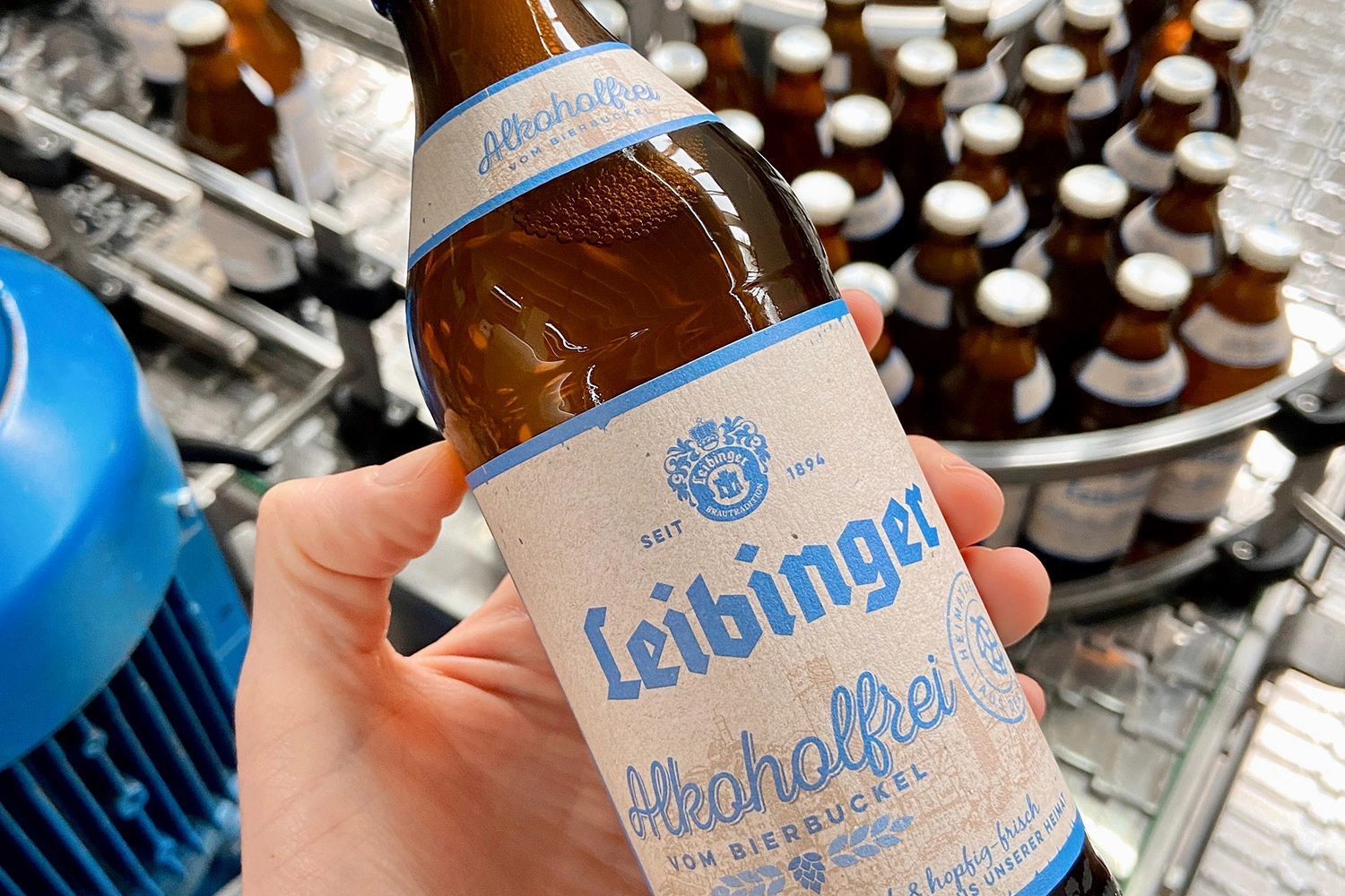 One hand holds a Leibinger beer bottle