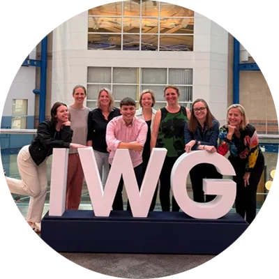 P&G delegates attending the IWG Women & Sport Summit in Birmingham pose beside the event's IWG display.