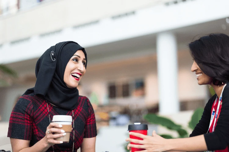 Sam Latif laughing in the company of another woman