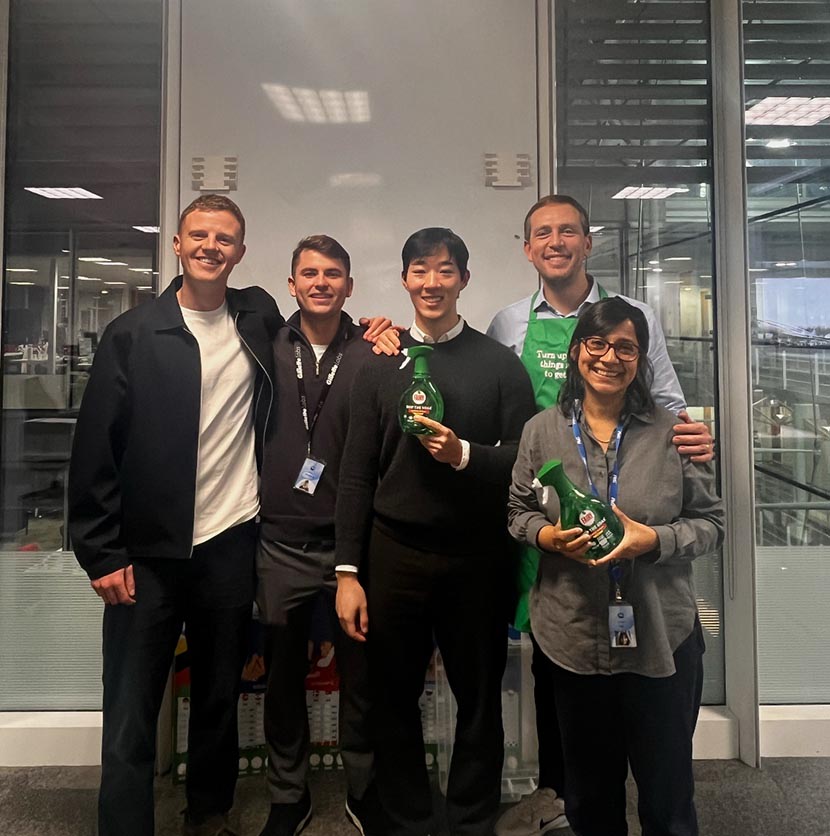 Group photo of five colleagues smiling and holding bottles of Fairy Skip The Soak bottles.