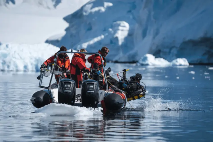 Basecamp research crew on Antarctica in a boat with diver Emma Bolton