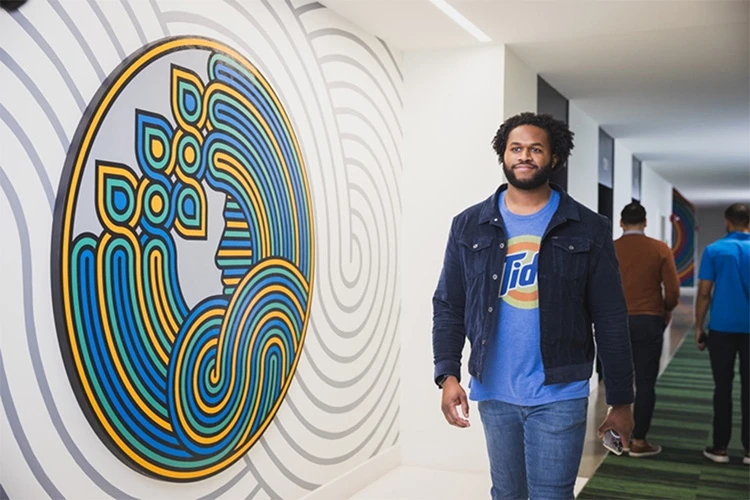 Male P&G employee walking down hall in Tide t-shirt