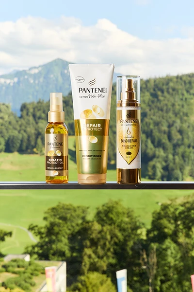 Pantene Repair & Protect collection and nature landscape in the background