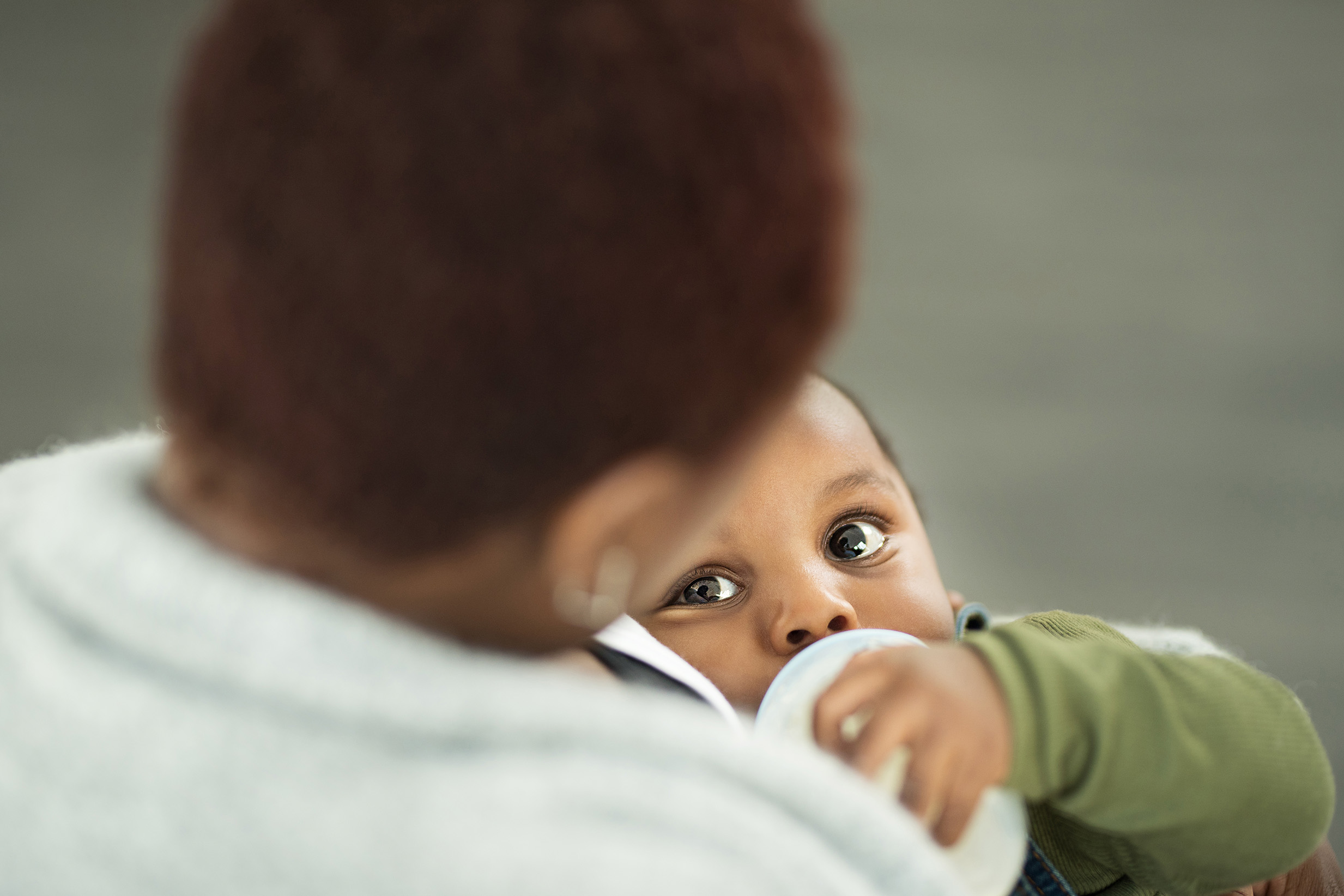 Mother with baby drinking bottle 2466x1644
