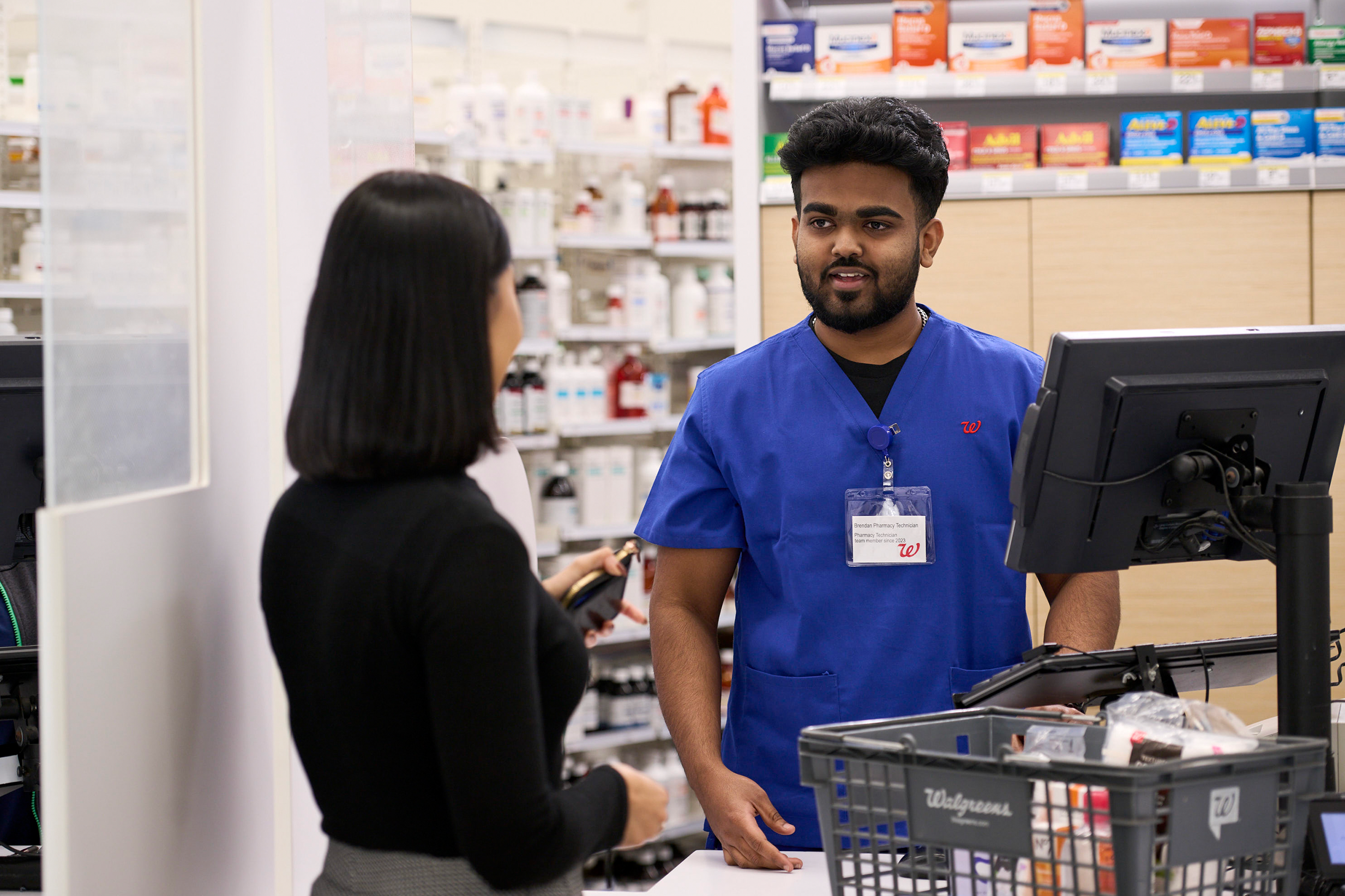 Walgreens pharmacist with customer