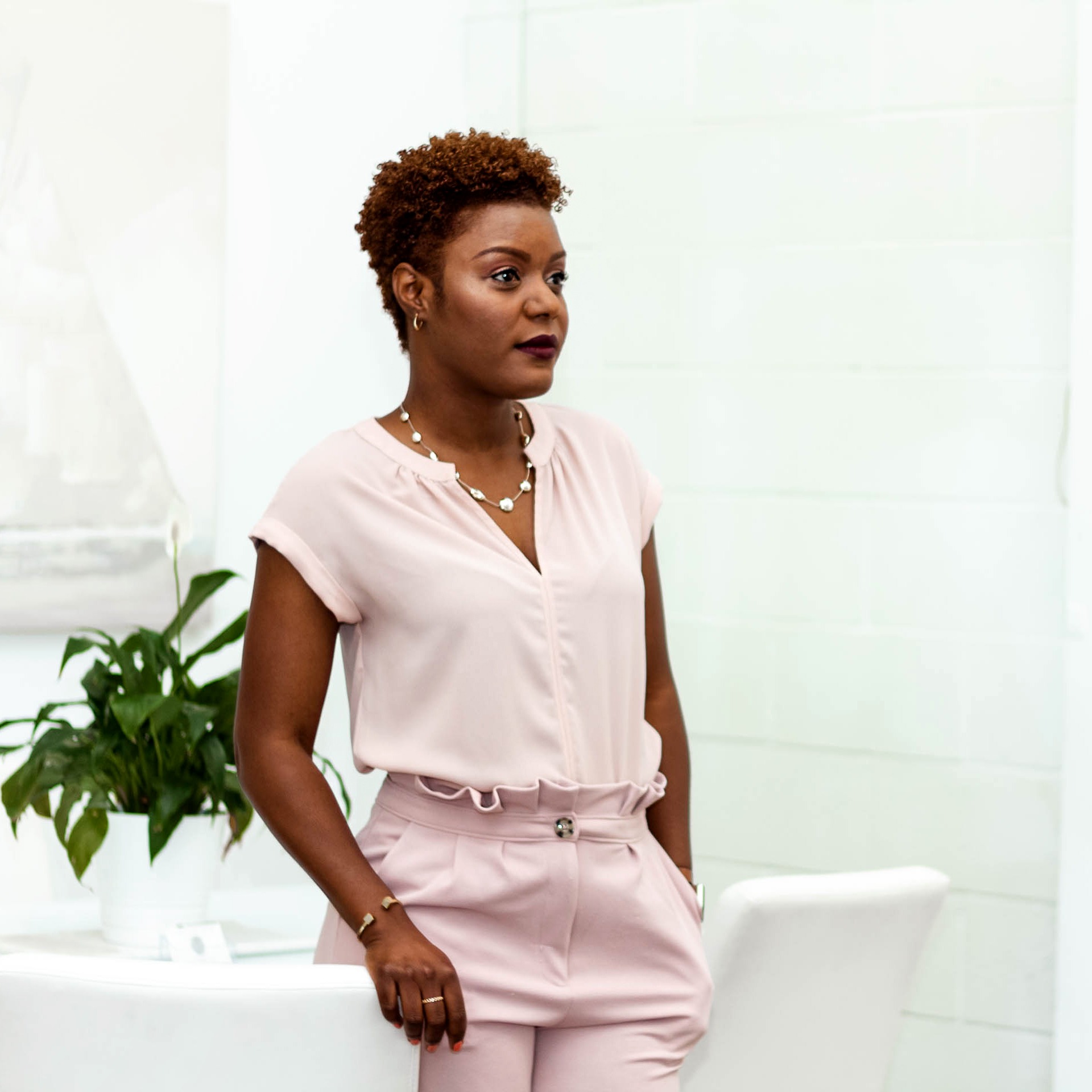 Young woman looks at reflection in mirror.