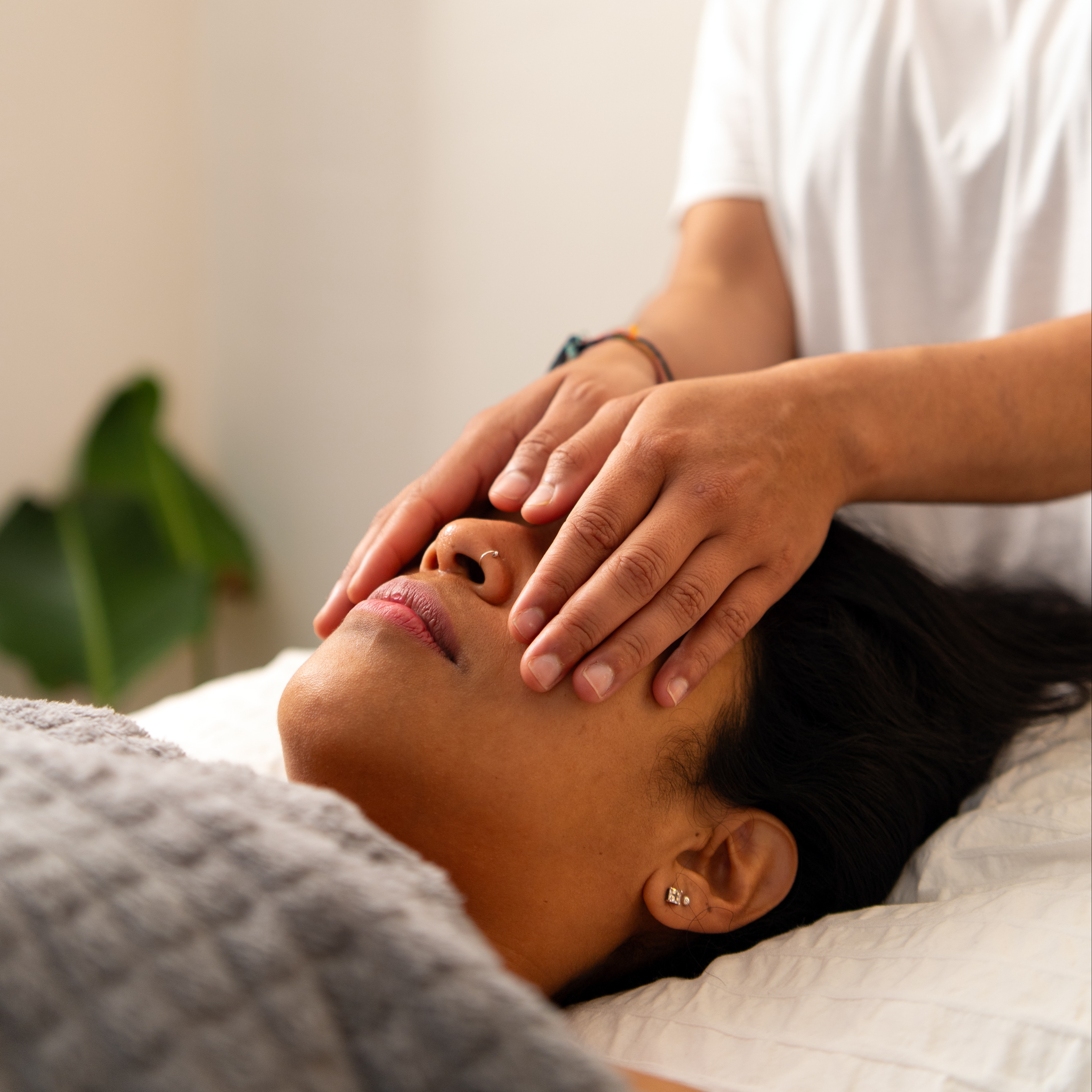 Person lying down, receiving Reiki